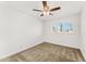 Clean, carpeted bedroom with a ceiling fan and a bright window at 8443 E Sheridan St, Scottsdale, AZ 85257