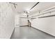 An empty garage featuring white walls, a concrete floor, garage door track, and a utility closet at 8443 E Sheridan St, Scottsdale, AZ 85257