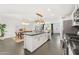 Modern kitchen island and view of the dining area and living room at 8443 E Sheridan St, Scottsdale, AZ 85257