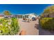 Spacious backyard with desert landscaping, patio, and mature cactus, offering a serene outdoor retreat at 8500 E Southern Ave # 551, Mesa, AZ 85209