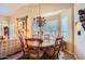 Dining area featuring a round table, chairs, decorative lighting, and large windows at 9130 E Crystal Dr, Sun Lakes, AZ 85248