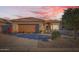 Charming single-story home features a well-kept yard, desert landscaping, and a warm, inviting facade at 9130 E Crystal Dr, Sun Lakes, AZ 85248