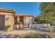 Inviting single-story home with gated front patio and desert landscaping with a tiled roof at 9130 E Crystal Dr, Sun Lakes, AZ 85248