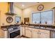 Well-lit kitchen featuring a stainless steel range, sink, and granite countertops at 9130 E Crystal Dr, Sun Lakes, AZ 85248