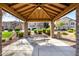 Community gazebo featuring stone pillars, a picnic table, and a well-maintained lawn at 923 W Wendy Way, Gilbert, AZ 85233