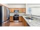 Modern kitchen featuring stainless steel appliances, granite countertops, and wood cabinets at 923 W Wendy Way, Gilbert, AZ 85233