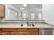 Kitchen sink featuring granite countertops, stainless steel dishwasher, and wood cabinets at 923 W Wendy Way, Gilbert, AZ 85233