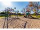 Beautiful playground with slides and swings, on a sand base with lush greenery and mature trees on a sunny day at 923 W Wendy Way, Gilbert, AZ 85233