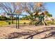 Community playground with slides and swings, perfect for Gathering fun, surrounded by well-maintained grass and mature trees at 923 W Wendy Way, Gilbert, AZ 85233