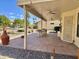 Relaxing back patio with tile floor, covered area, and a hammock, perfect for enjoying the outdoors at 9238 W Behrend Dr, Peoria, AZ 85382