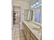 Bright bathroom with a dual sink vanity and a shower with sliding glass doors at 9238 W Behrend Dr, Peoria, AZ 85382