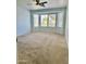 Spacious bedroom with natural light from a large bay window and neutral carpeting at 9238 W Behrend Dr, Peoria, AZ 85382