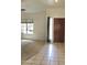 Welcoming entryway with tiled floors, natural light, and a glimpse of the spacious, carpeted living area at 9238 W Behrend Dr, Peoria, AZ 85382