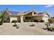 Attractive single-story home showcasing Southwestern desert landscaping, solar panels and a two-car garage at 9238 W Behrend Dr, Peoria, AZ 85382