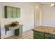 Kitchen desk area with green cabinets, granite counters, tile floors, and extra storage space in an open layout at 9238 W Behrend Dr, Peoria, AZ 85382