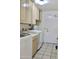 Functional laundry room featuring cabinetry for storage and tiled flooring for easy maintenance at 9238 W Behrend Dr, Peoria, AZ 85382