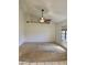 Bright living room with neutral carpet, vaulted ceiling, ceiling fan, and a large window providing natural light at 9238 W Behrend Dr, Peoria, AZ 85382