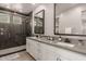 Modern bathroom with a walk-in shower, dual sinks, and sleek countertops at 9716 E Resistance Ave, Mesa, AZ 85212