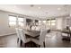 Open concept dining area with modern table and chairs, flowing into the living room space at 9716 E Resistance Ave, Mesa, AZ 85212