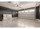 View of a spacious two car garage with epoxy flooring, black accent wall, and an electric car charger at 9716 E Resistance Ave, Mesa, AZ 85212