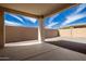 Covered patio area featuring a concrete floor and gravel landscaping at 9716 E Resistance Ave, Mesa, AZ 85212