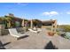 Resort-style backyard featuring desert landscaping, pool, lounge chairs and covered outdoor dining area at 9887 E Palo Brea Dr, Scottsdale, AZ 85262