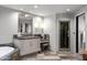 Bathroom with a large mirror, vanity with a sink, and a glass shower at 9887 E Palo Brea Dr, Scottsdale, AZ 85262