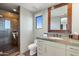 Bathroom with a tiled shower, a large mirror and a vanity with granite countertops at 9887 E Palo Brea Dr, Scottsdale, AZ 85262