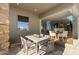 Covered outdoor dining area features a large table with seating for six and desert views at 9887 E Palo Brea Dr, Scottsdale, AZ 85262