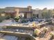 Outdoor entertaining space showcasing stacked stone accents, a spacious patio, water feature and lush desert landscaping at 9887 E Palo Brea Dr, Scottsdale, AZ 85262