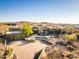 Expansive desert home with a circle driveway, desert landscaping, and a seamless blend with the natural surroundings at 9887 E Palo Brea Dr, Scottsdale, AZ 85262