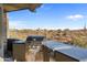 Modern outdoor kitchen with stainless steel grill and counter space overlooking desert landscape at 9887 E Palo Brea Dr, Scottsdale, AZ 85262