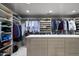 Large walk-in closet with custom shelves, hanging rods, and drawers at 9887 E Palo Brea Dr, Scottsdale, AZ 85262