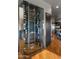 Glass enclosed wine cellar adjacent to modern kitchen at 9887 E Palo Brea Dr, Scottsdale, AZ 85262