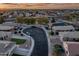 Beautiful aerial view of a residential neighborhood, showcasing well-maintained homes and community streets at dusk at 1013 S Hazel Ct, Gilbert, AZ 85296