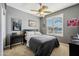 Bedroom with a ceiling fan, plantation shutters, and neutral decor at 1013 S Hazel Ct, Gilbert, AZ 85296