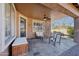 Inviting covered patio with stylish seating, fan, and view of the pool, perfect for outdoor relaxation and entertainment at 1013 S Hazel Ct, Gilbert, AZ 85296