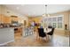 Well-lit kitchen featuring modern appliances, granite countertops, and an adjacent dining area at 1013 S Hazel Ct, Gilbert, AZ 85296