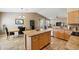 Bright and airy kitchen with an island, and a connected living and dining space at 1013 S Hazel Ct, Gilbert, AZ 85296