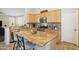 Spacious kitchen island with granite countertops, light wood cabinets, and stainless appliances at 1013 S Hazel Ct, Gilbert, AZ 85296