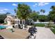 Spacious backyard featuring a pool, outdoor seating area with firepit, and well-manicured lawn at 10440 E Larkspur Dr, Scottsdale, AZ 85259