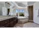 Tiled primary bathroom with a separate shower and soaking tub at 10440 E Larkspur Dr, Scottsdale, AZ 85259