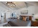 Serene main bedroom with a sitting area, chandelier, and ample natural light at 10440 E Larkspur Dr, Scottsdale, AZ 85259