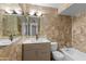 Bathroom featuring updated vanity and a tub with tiled walls at 10611 N 9Th Dr, Phoenix, AZ 85029