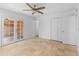 Well-lit bedroom with ceiling fan, closet, and french doors at 10611 N 9Th Dr, Phoenix, AZ 85029