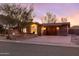 Charming home featuring desert landscaping, a brick driveway, and warm exterior lighting at 10611 N 9Th Dr, Phoenix, AZ 85029