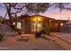 Inviting home with desert landscaping, a stone bench, and large picture window showcasing a bright interior at 10611 N 9Th Dr, Phoenix, AZ 85029