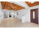 Open-concept kitchen and living area featuring white cabinets, stainless steel appliances, and wood plank ceiling at 10611 N 9Th Dr, Phoenix, AZ 85029