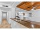 An inviting kitchen and open bar featuring modern appliances and a warm, wood-paneled ceiling at 10611 N 9Th Dr, Phoenix, AZ 85029