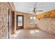 Sunroom featuring brick walls and floors, and a ceiling fan at 10611 N 9Th Dr, Phoenix, AZ 85029